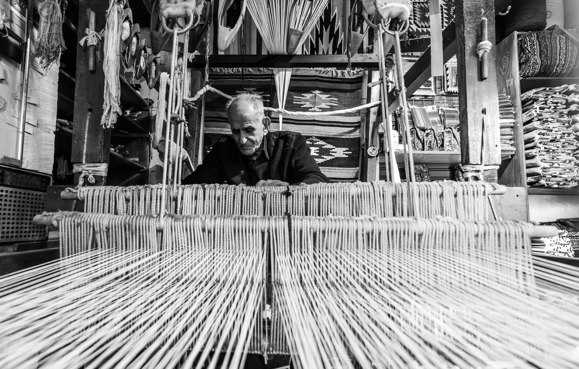 A Turkish master weaver at his traditional loom in Denizli